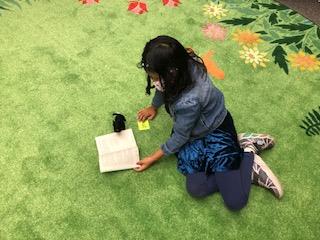 student reading to a reading buddy